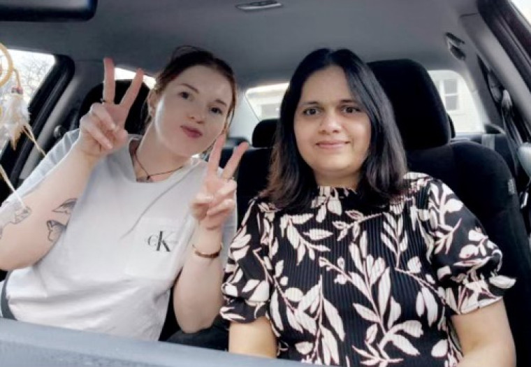 Sandy Kaur (pictured right) sitting in a car with a friend.