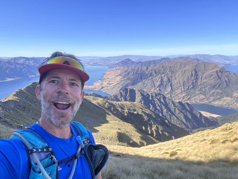 Chris Mawson taking a selfie in front of a scenic background.