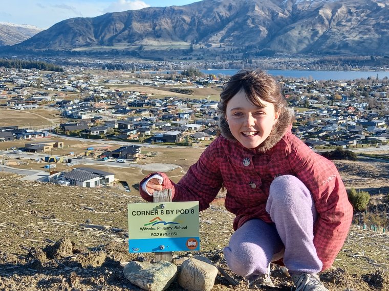 Young volunteer Anika West outside on a hill top volunteering