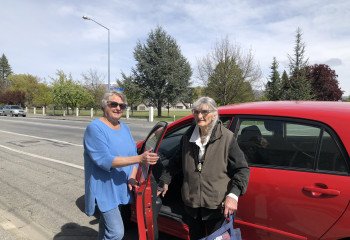 Volunteer Barbara Paul picking up Roz Carter in her car.