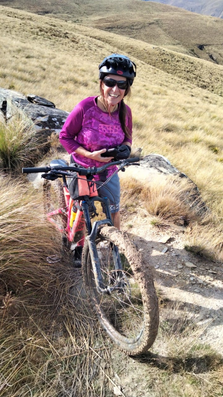 Penny on her bike on a mountain trail