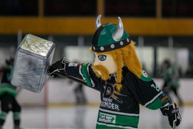 Thor, the Dunedin Phoenix Thunder Ice Hockey team's mascot, out on the ice, holding up his hammer.