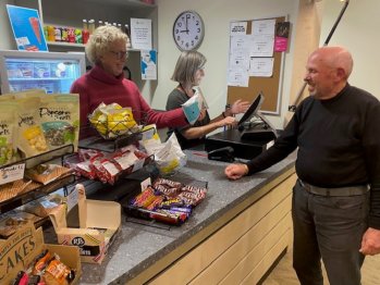 Volunteers serving customers at the box office.